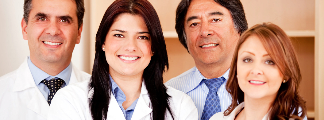 four medical staff smiling